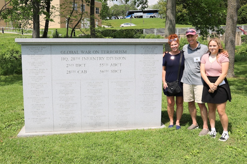 Family members of Master Sgt. Sean Thomas, a 28th Infantry Division soldier killed in Iraq in March 2007, pause for a photo next to the Global War on Terrorism monument on the grounds of the Pennsylvania Military Museum in Boalsburg, Pa. From left are Thomas' sister, Melinda Flick; his brother-in-law David Balestrini; and Thomas's daughter, Alexa Thomas.