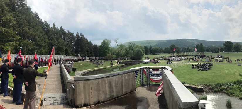 The grounds of the 28th Infantry Division shrine in Boalsburg stretch out in front of division soldiers holding guidons during the Iron Division's annual memorial service May 22, 2022.