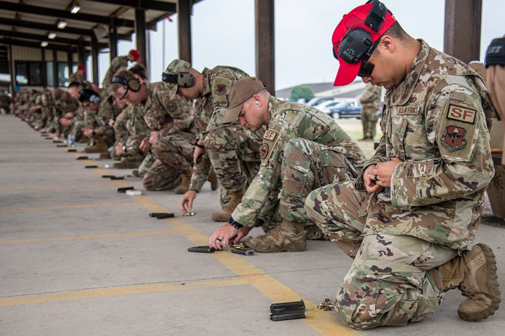 Military members preparing weapons.