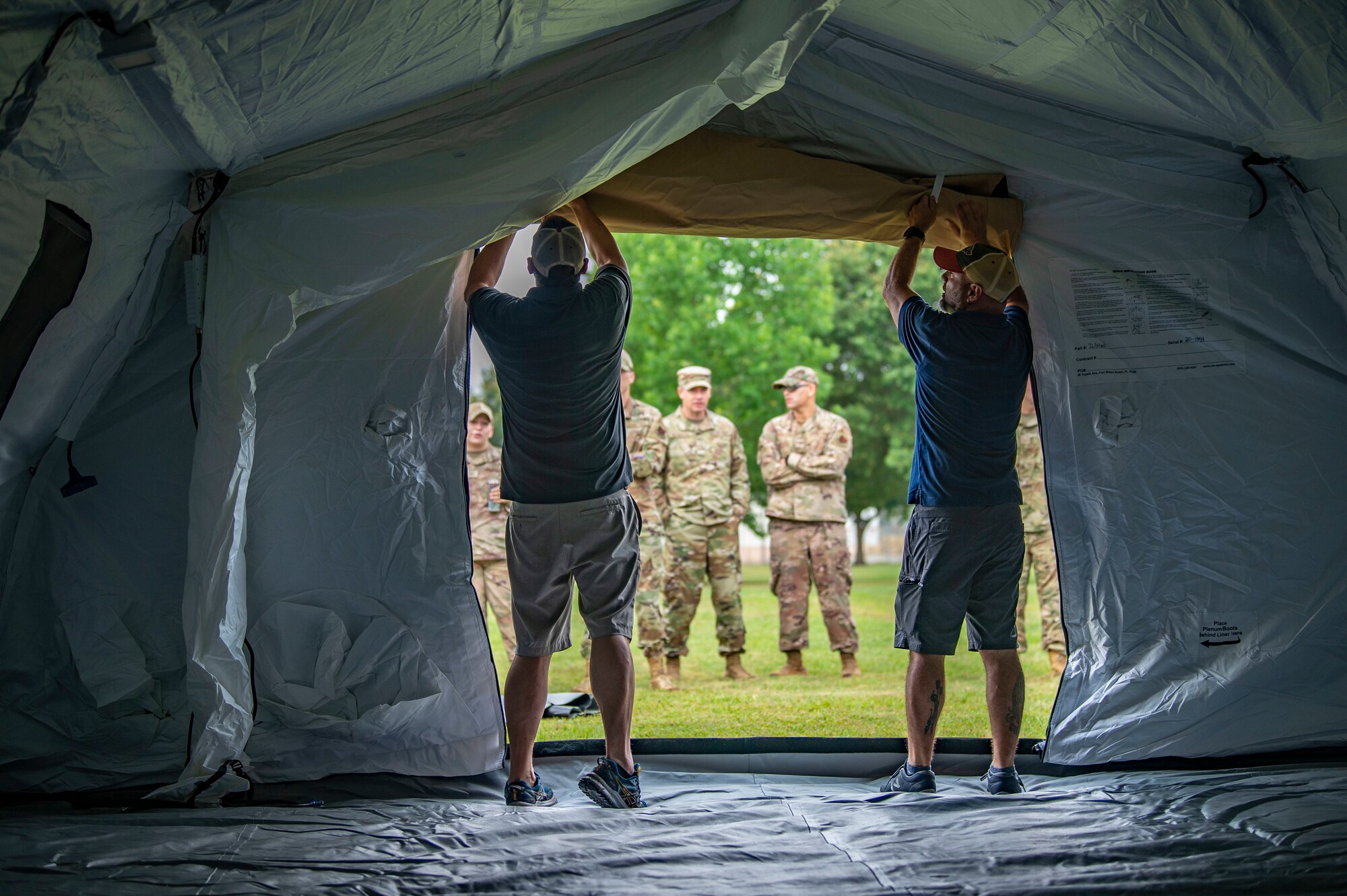 two men opening a tent