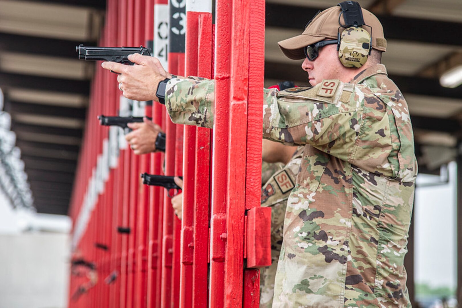 Military members shooting on a range