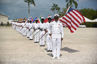 A member of the Belize coast guard sounds off before departing the parade field at the conclusion of the closing ceremony of Tradewinds 2022 in Belize City, Belize, on May 20, 2022.