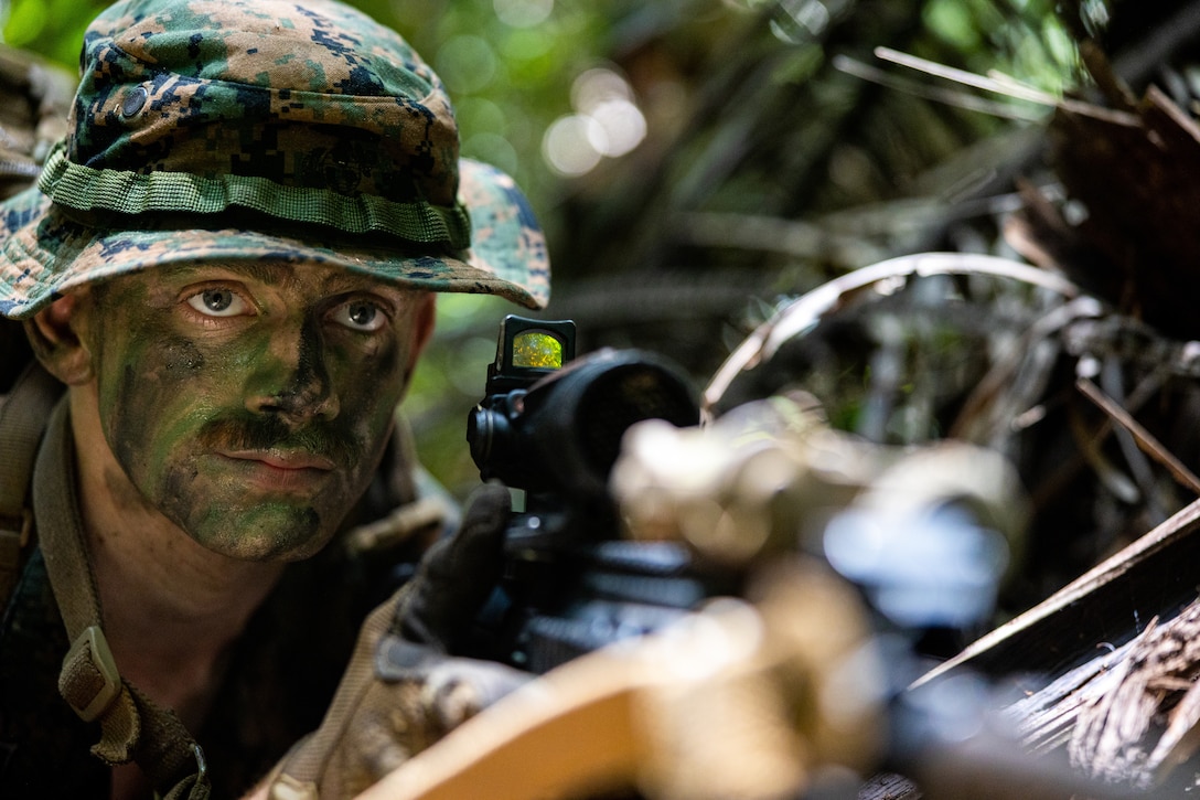 U.S. Marine Corps Lance Cpl. Micah Dunford, an infantry Marine with India Company, 3rd Battalion, 25th Marine Regiment, 4th Marine Division, examines his surroundings while posting security during exercise Tradewinds 2022 (TW22) at Guacamallo Bridge, Belize, on May 13, 2022.