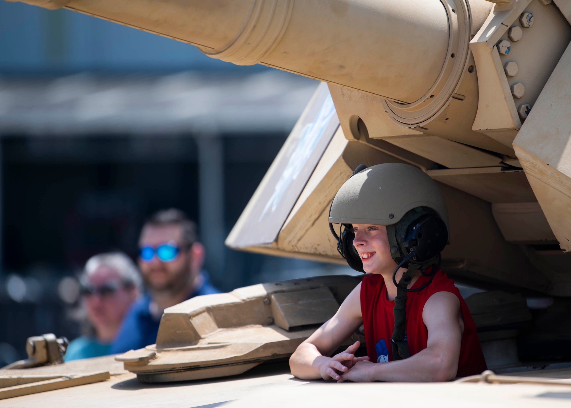 A spectator poses in a M1A1 Abrams during the 2022 Thunder Over Dover Airshow, May 22, 2022, at Dover Air Force Base, Delaware. The show featured more than 20 different military and civilian aircraft from all branches of service. (U.S. Air Force photo by Tech. Sgt. J.D. Strong II)