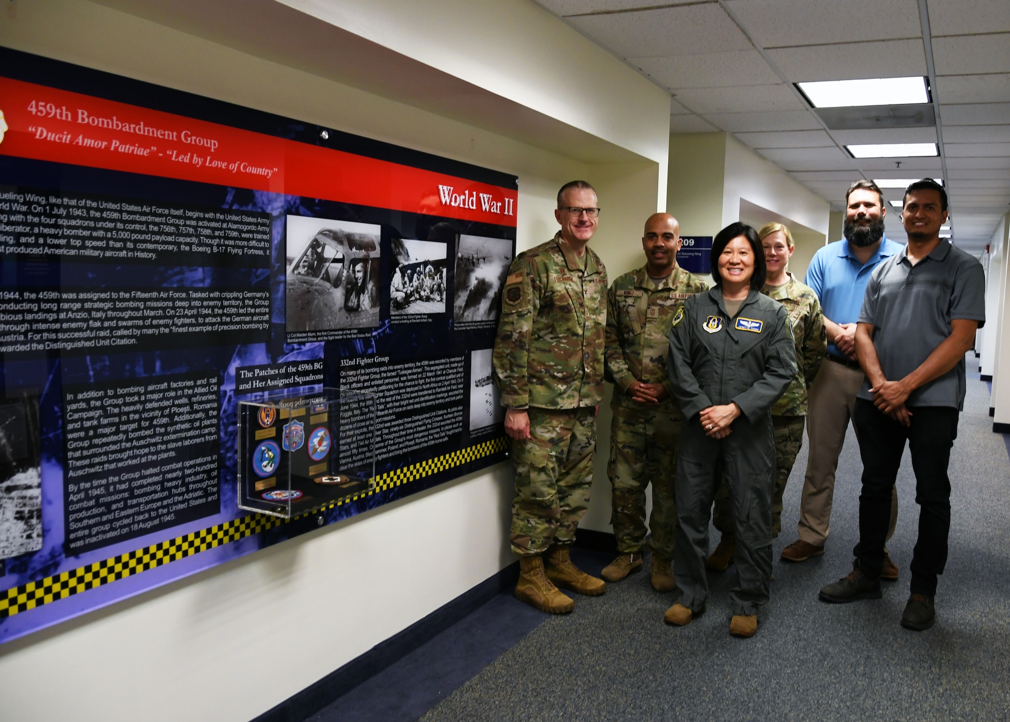 The 459th Air Refueling Wing’s leadership team gathers next to one of the headquarters’ new heritage panels designed by wing historian Julius Lacano (2nd from right), May 16, 2022. Lacano was recently awarded the Air Force Reserve Command Heritage Award for leading this project over the course of eight months. The historian designed the project as a way to educate servicemembers on the wing’s history that began in 1943. This project falls squarely in line with leadership’s goal to develop resilient, committed, combat-ready Airmen. The wing’s three inspiring historical displays can be viewed on the south hallway on the second floor of the Wing’s HQ.  (U.S. Air Force photo by Tech Sgt. Cierra Presentado)