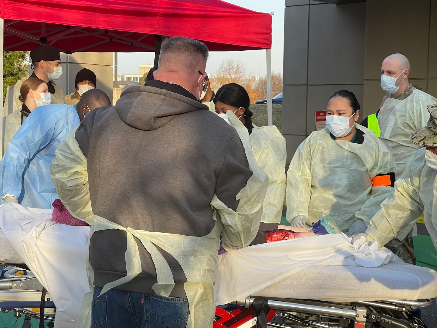 Emergency response staff and nurses of the Walter Reed National Military Medical Center (WRNMMC) conducts an emergency response simulation exercise outside the emergency room at WRNMMC, December 7, 2021. The simulation exercise was to test the hospital's capacity to respond to emergencies.