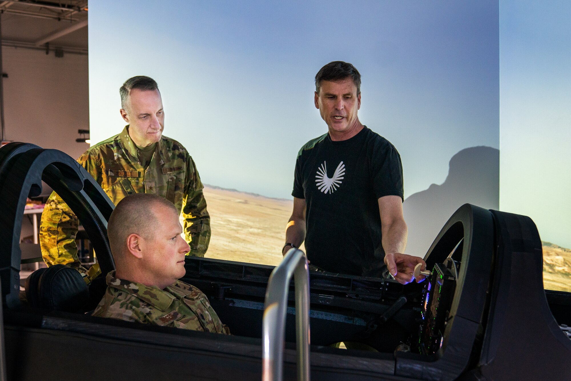 Brig. Gen. Jason Lindsey, Presidential and Executive Airlift PEO, (left), looks on as Lt. Col. Joshua Burger operates Boom Supersonics’ XB-1 Flight Simulator to a successful landing. (Courtesy photo)