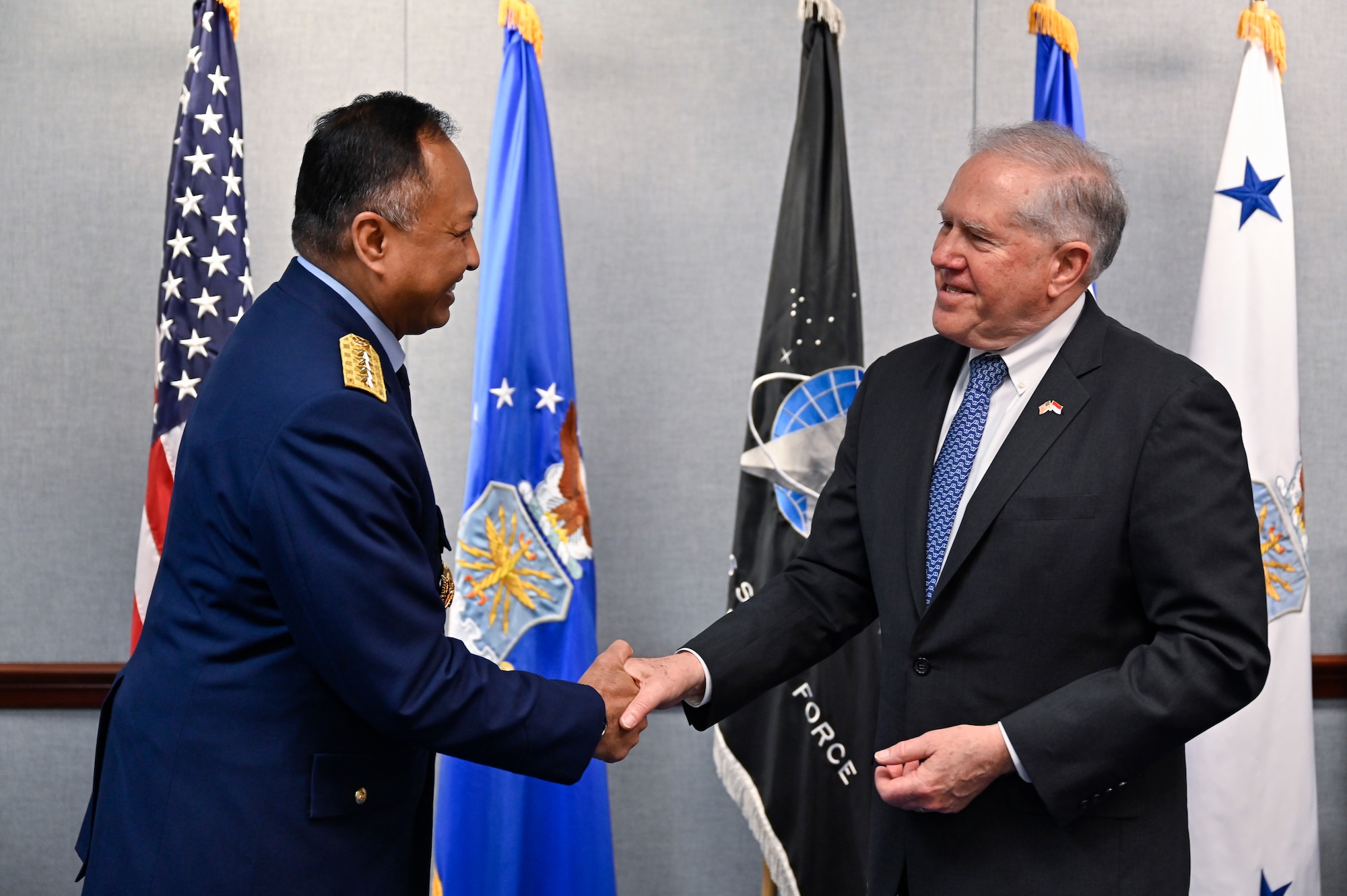 Secretary of the Air Force Frank Kendall, right, shakes hands with Air Chief Marshal Fadjar Prasetyo.