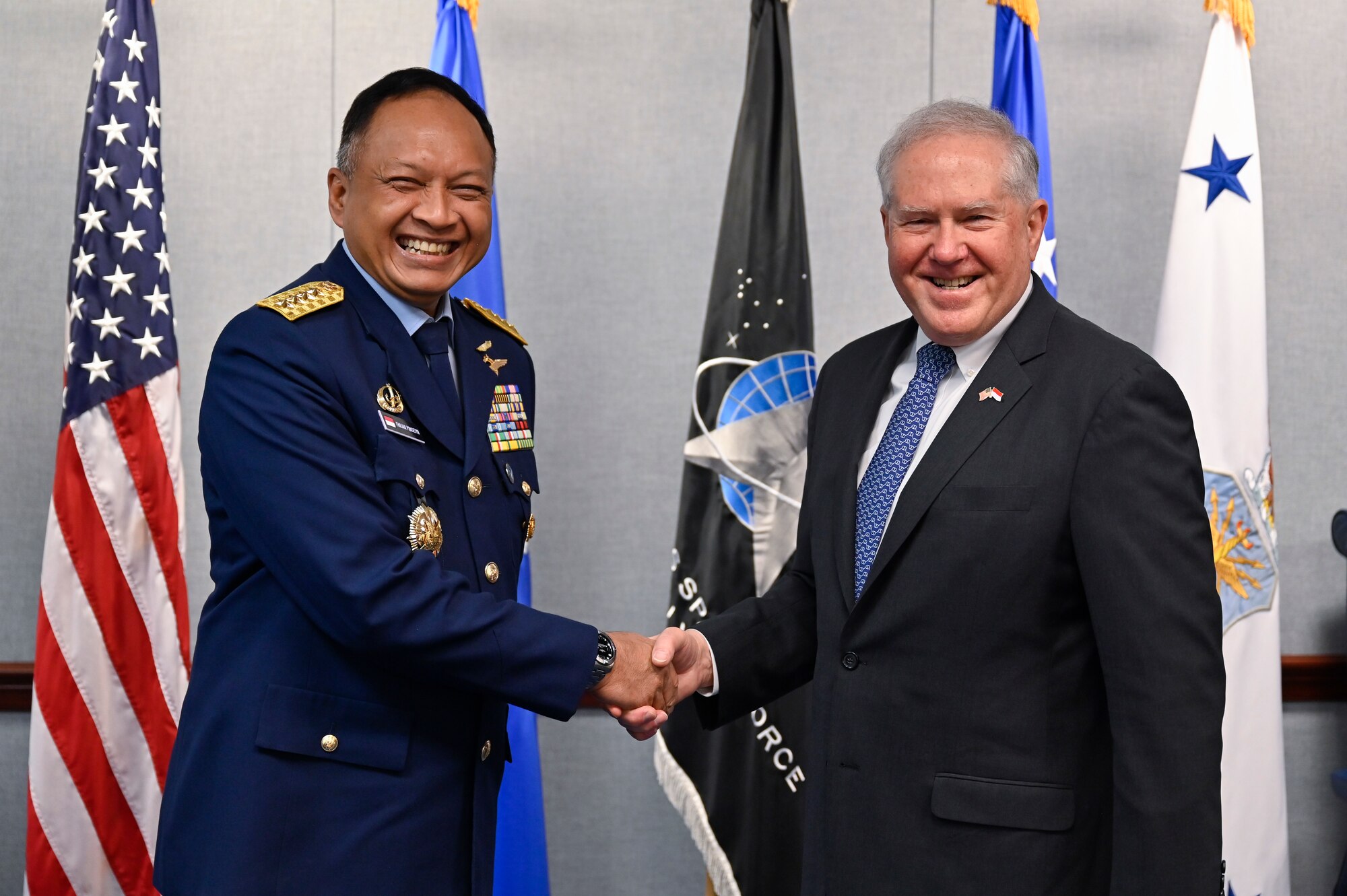 Secretary of the Air Force Frank Kendall, right, shakes hands with Air Chief Marshal Fadjar Prasetyo.