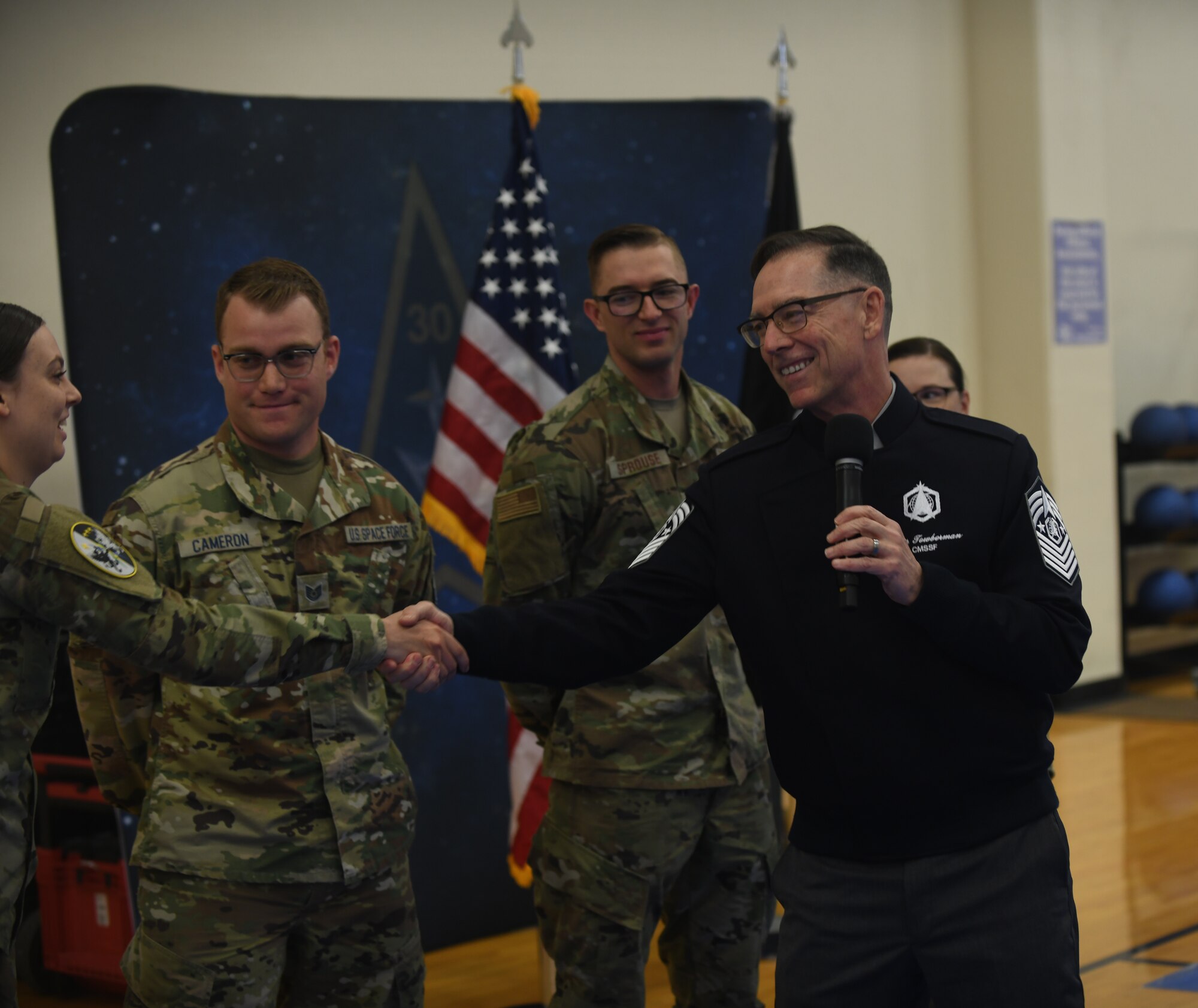 Chief Master Sgt. of the Space Force, Roger A. Towberman, shakes the hand of a fellow Guardian during an all-call held on Vandenberg Space Force Base, Calif., May 20, 2022. CMSSF Towberman awarded his coin to six Airmen and Guardians for going above and beyond their duties on base. (U.S. Space Force photo by Airman 1st Class Ryan Quijas)