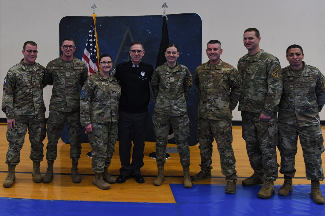 Chief Master Sgt. of the Space Force, Roger A. Towberman, poses for a photo with Airmen and Guardians who were awarded his coin during an all-call on Vandenberg Space Force Base, Calif., May 20, 2022. CMSSF Towberman gave his coin to six service members for going above and beyond their duties on base. . (U.S. Space Force photo by Airman 1st Class Ryan Quijas)