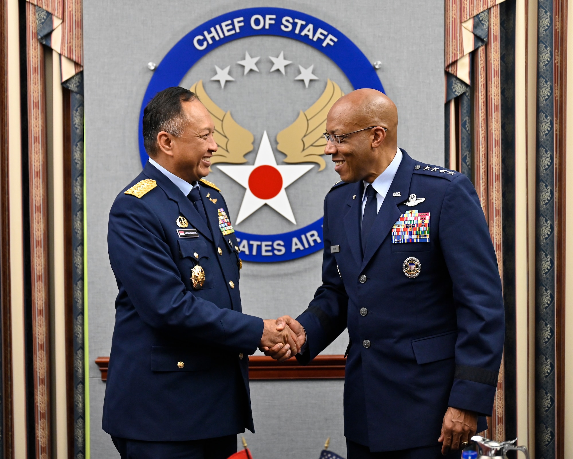 Air Force Chief of Staff Gen. CQ Brown, Jr., right, shakes hands with Air Chief Marshal Fadjar Prasetyo, chief of staff of the Indonesian Air Force.