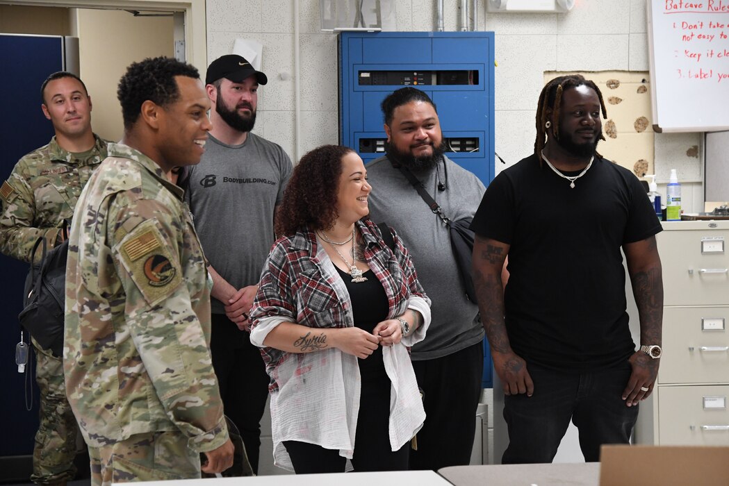 U.S. Air Force Maj. Justin Handley, 81st Communications Squadron commander, provides a tour of the 81st CS building to Amber Najm and her husband, T-Pain, an American rapper, at Keesler Air Force Base, Mississippi, May 19, 2022. Amber served in the Air Force and was assigned to the 81st CS from 2001-2004. (U.S. Air Force photo by Kemberly Groue)