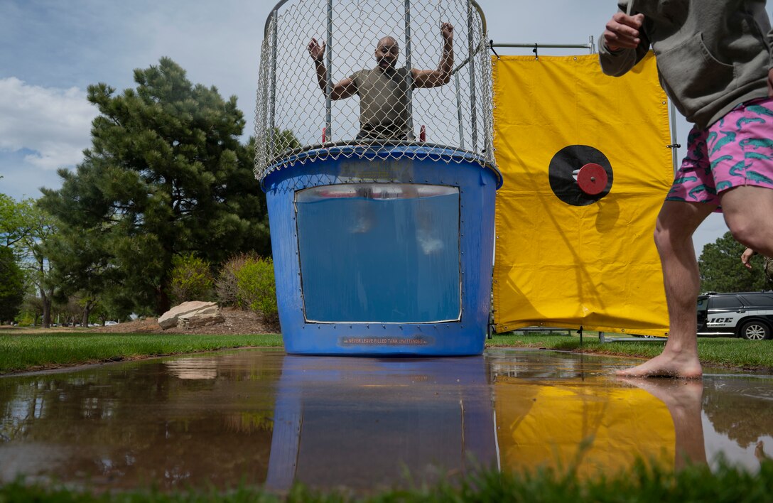 U.S. Air Force Senior Airman Julian Wair, 21st Security Forces Squadron base defense operations center controller, is dunked into a water tank during the Defender’s Fair at Peterson Space Force Base, Colorado, May 19, 2022. The fair was one of seven events hosted by the 21st and 50th SFS’s to celebrate Police Week. (U.S. Space Force photo by Senior Airman Jonathan Whitely)