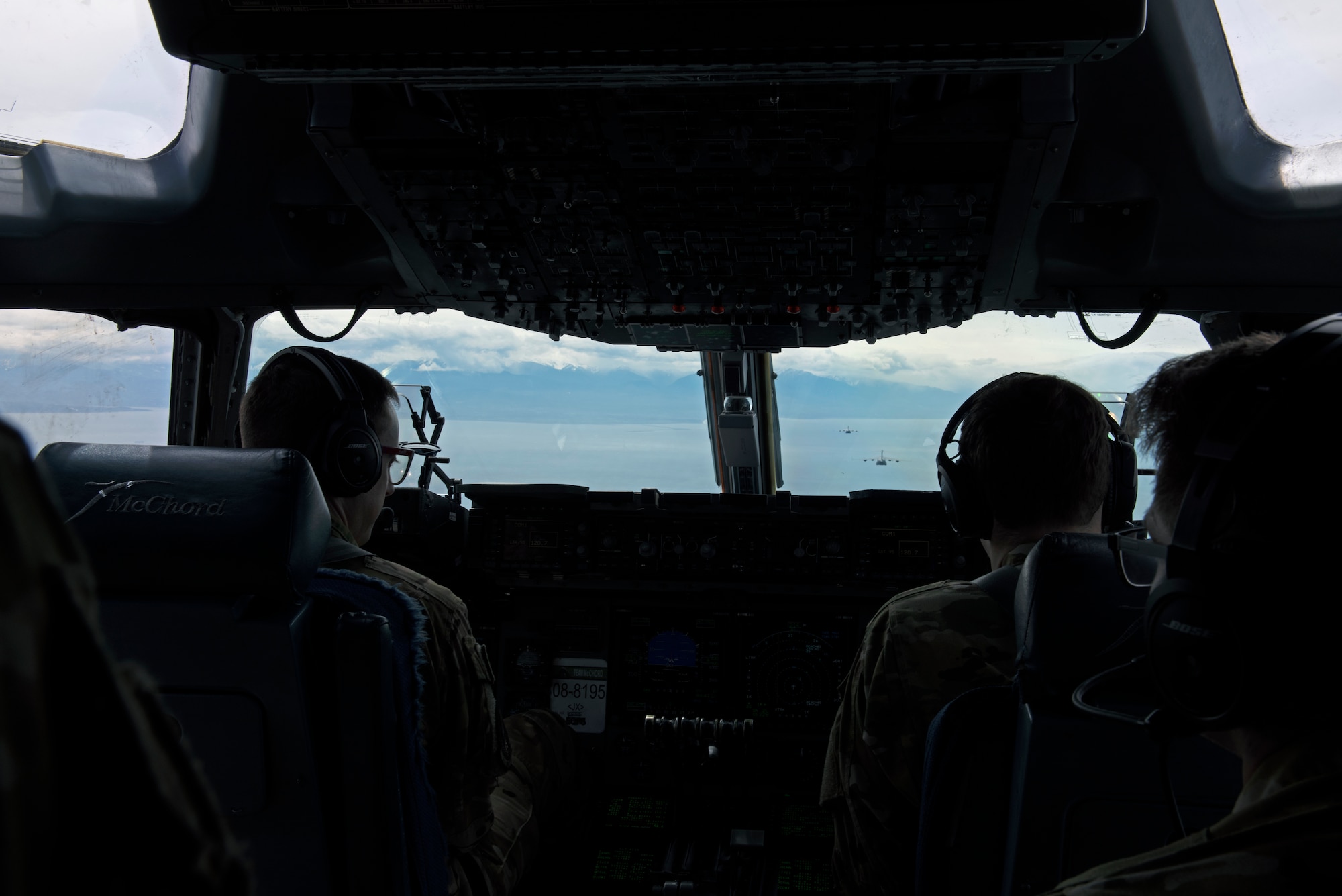 Pilots with the 7th  and 8th Airlift Squadron prepare for aerial refueling over the Pacific Ocean during Exercise Swift Response, May 7, 2022. Exercise Swift Response  focuses on building airborne interoperability with Allies and partners, and the integration of joint service partners in a contested environment; testing the capability and operational reach to rapidly deploy and employ U.S. and Europe-based multi-national airborne forces with little to no warning from across the globe. (U.S. Air Force photo by Staff Sergeant Zoe Thacker)