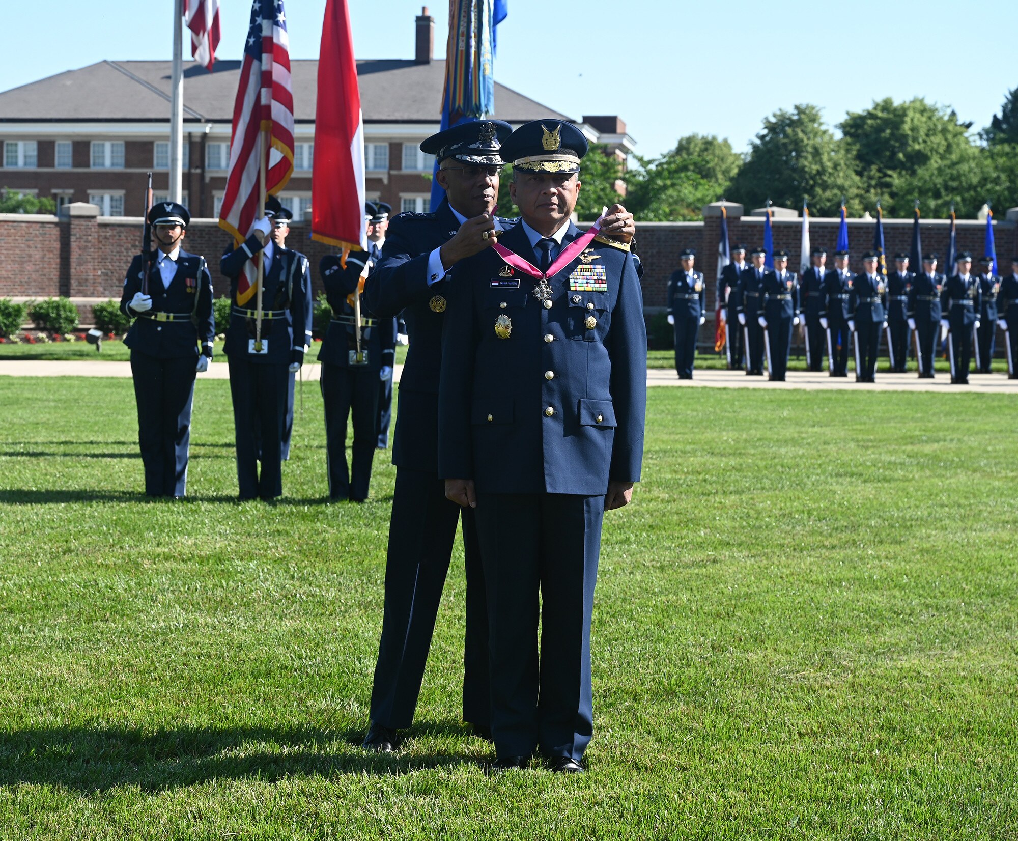 Air Force Chief of Staff Gen. CQ Brown, Jr. presents the Legion of Merit medal to Air Chief Marshal Fadjar Prasetyo.