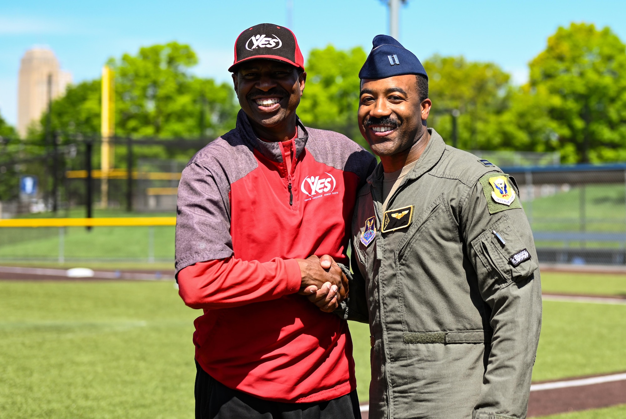 A U.S. Air Force B-2 Spirit pilot greets O.J. Rhone, Youth Excited about Sports Warrensburg director during Diversity in the Dugout at the Kansas City Royals Urban Youth Academy, Missouri, May 14, 2022. Rhone invited a pilot assigned to Whiteman to talk about hardships he faced as a young black man and overcoming negative views of diversity of those around him. This Juneteenth linked event is designed to educate kids on the importance of understanding diversity in a fun environment. (U.S. Air Force photo by Airman 1st Class Victoria Hommel)