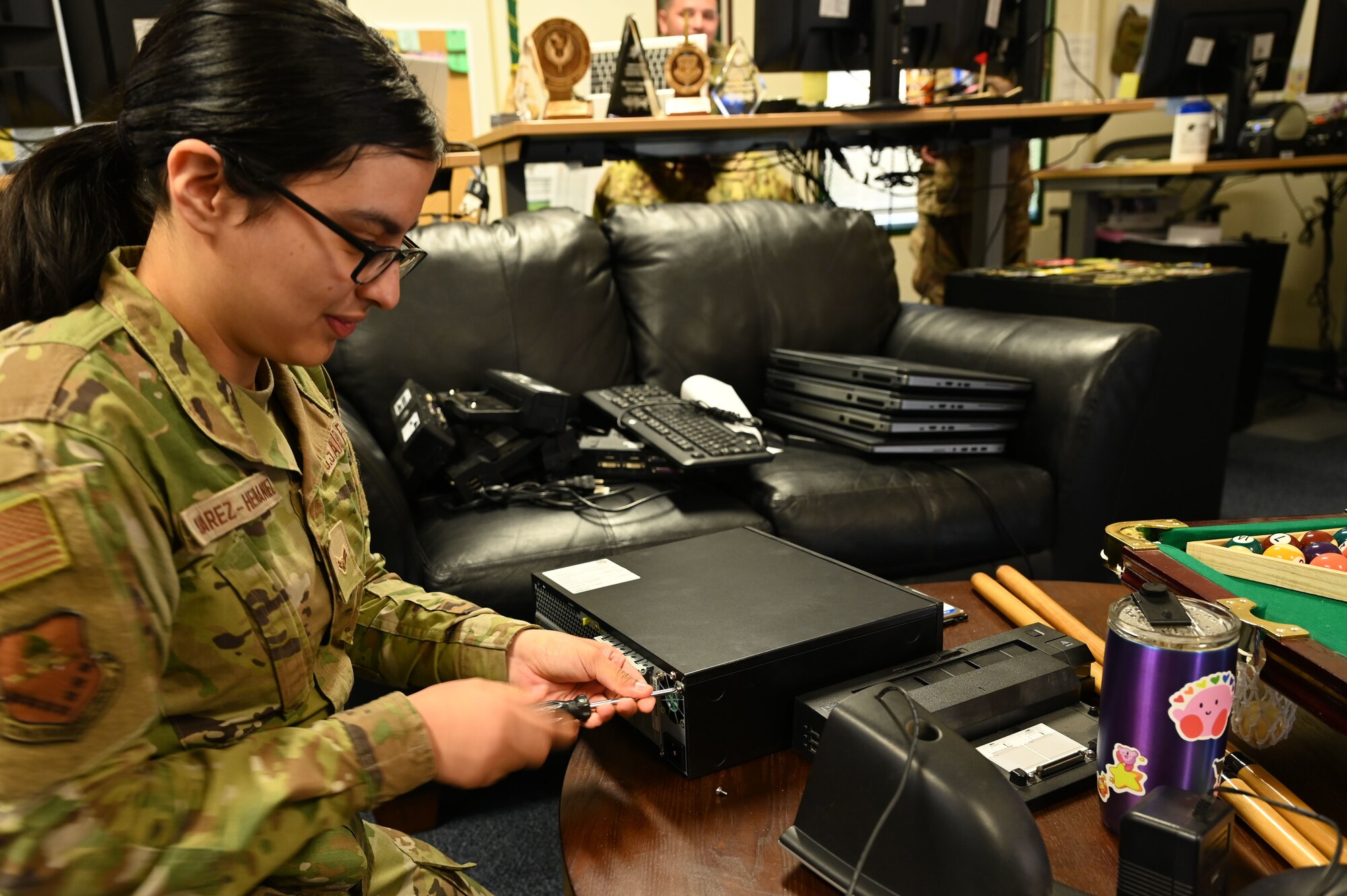 U.S. Air Force Airman 1st Class Arely Juarez Hernandez, client systems operator assigned to the 517th Training Group, opens a desktop computer case at Presidio of Monterey, Calif., May 12, 2022. Juarez Hernandez is trained to work on both hardware and software to support the 517th TRG mission. (U.S. Air Force photo by Master Sgt. Jocelyn A. Ford)