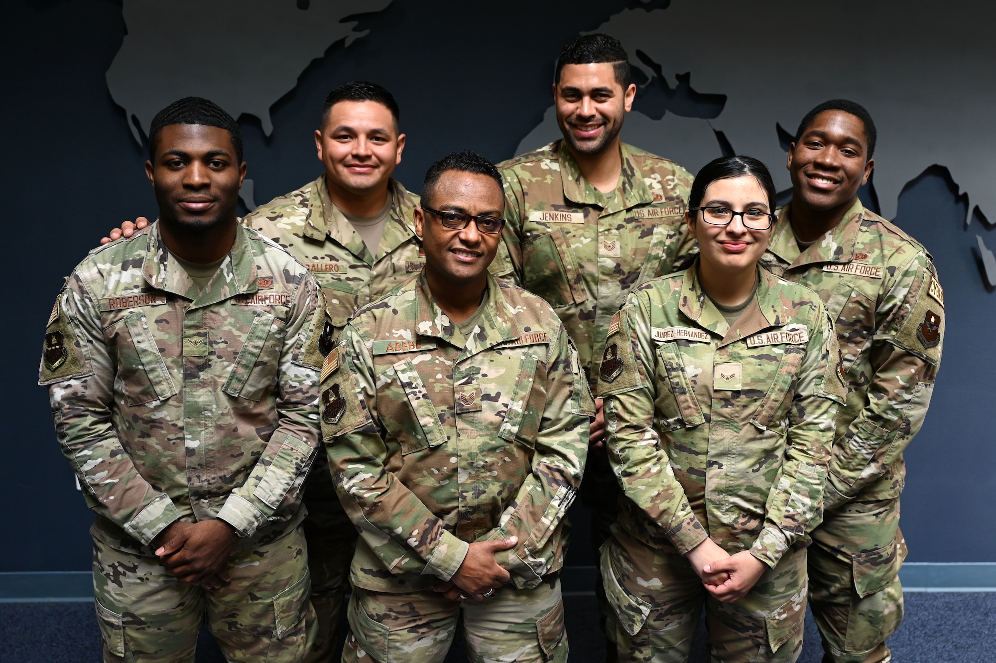 U.S. Air Force Airman 1st Class Arely Juarez Hernandez, client systems operator assigned to the 517th Training Group, (front right) poses with her office coworkers at Presidio of Monterey, Calif., May 12, 2022. Juarez Hernandez shared credit for any success to her teammates as they make the work environment enjoyable. (U.S. Air Force photo by Master Sgt. Jocelyn A. Ford)