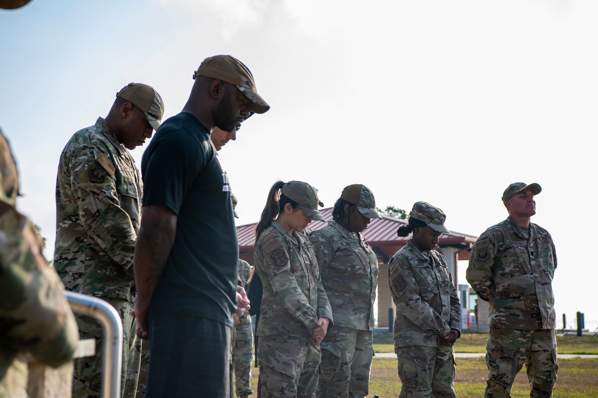 U.S. Air Force airmen assigned to the 6th Air Refueling Wing bow their heads during a prayer at MacDill Air Force Base, Florida, May 19, 2022.