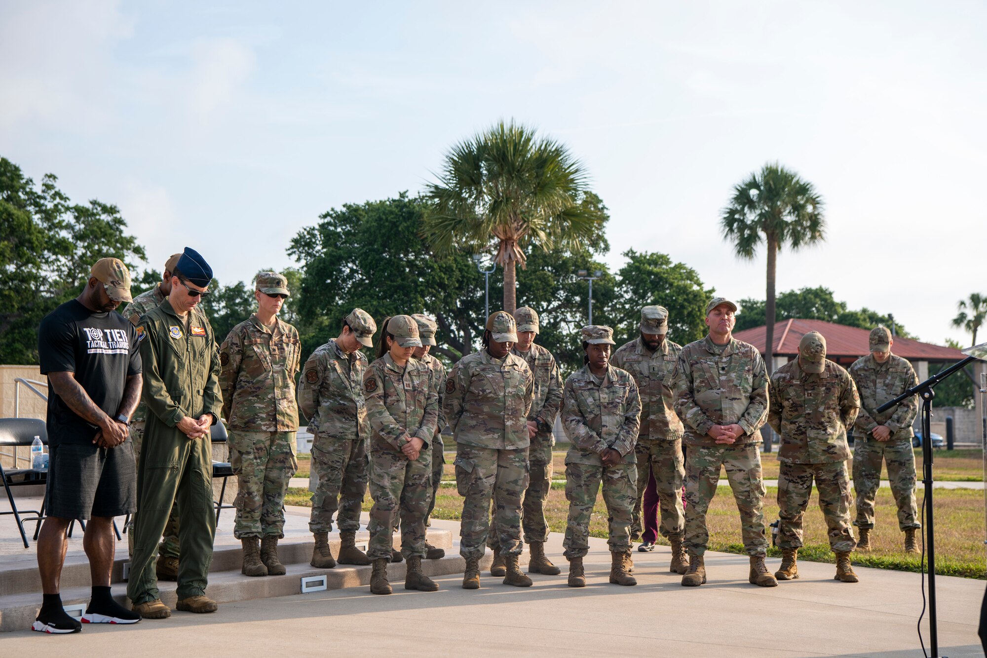 U.S. Air Force Airmen assigned to the 6th Air Refueling Wing bow their heads during a prayer vigil at MacDill Air Force Base, Florida, May 19, 2022. The Airmen gathered in light of recent violence nationwide and held a prayer for the country, victims and family members affected. (U.S. Air Force photo by Airman 1st Class Hiram Martinez)