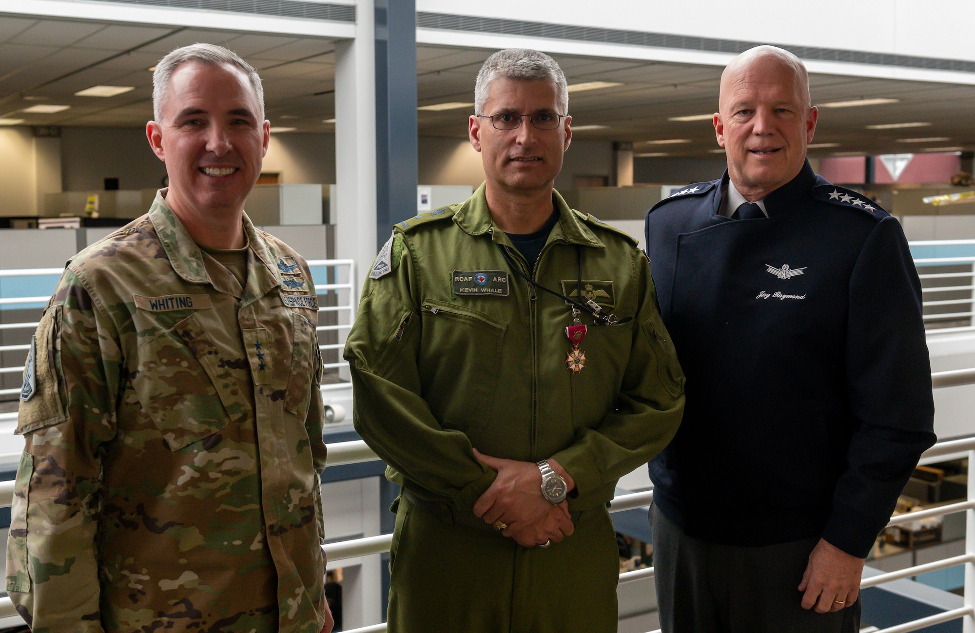 Canadian Royal Air Force Brig.-Gen. Kevin Whale, Space Operations Command, Deputy Commanding General of Transformation, poses with Chief of Space Operations Gen. John W. “Jay” Raymond and Lt. Gen. Stephen Whiting, Commander Space Operations Command, after receiving the Legion of Merit (Degree of Officer) at SpOC Headquarters, Peterson Space Force Base, Colorado, 24 May, 2022 (U.S. Space Force photo by Staff Sergeant Jose A. Rodriguez Jr)