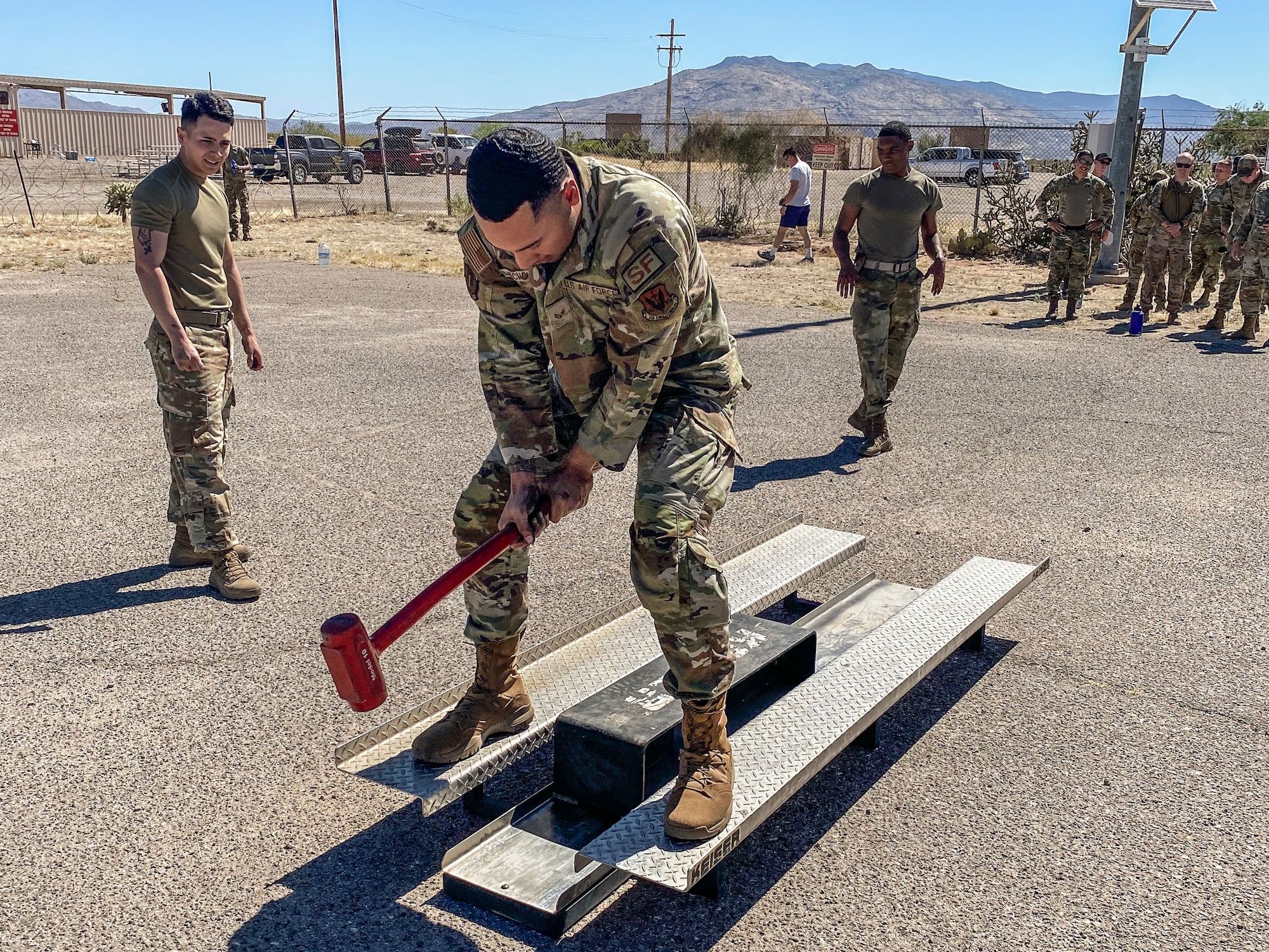 A photo of an Airman using a hammer.
