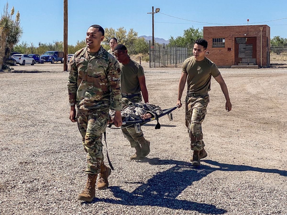 A photo of Airmen carrying a stretcher.