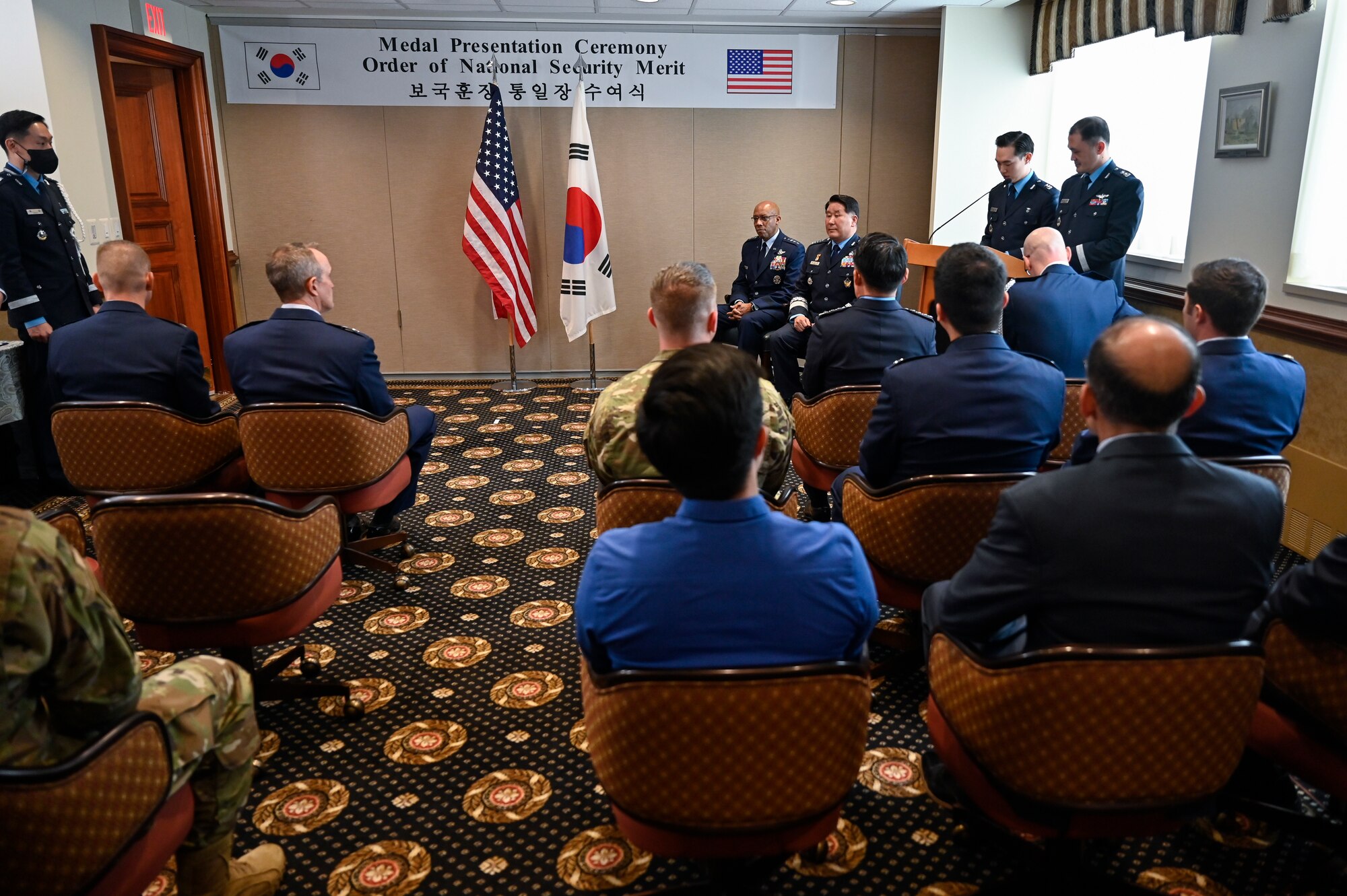 Air Force Chief of Staff Gen. CQ Brown, Jr., seated center left, and Chief of Staff of the Republic of Korea Air Force Gen. Park Inho sit during an award ceremony.