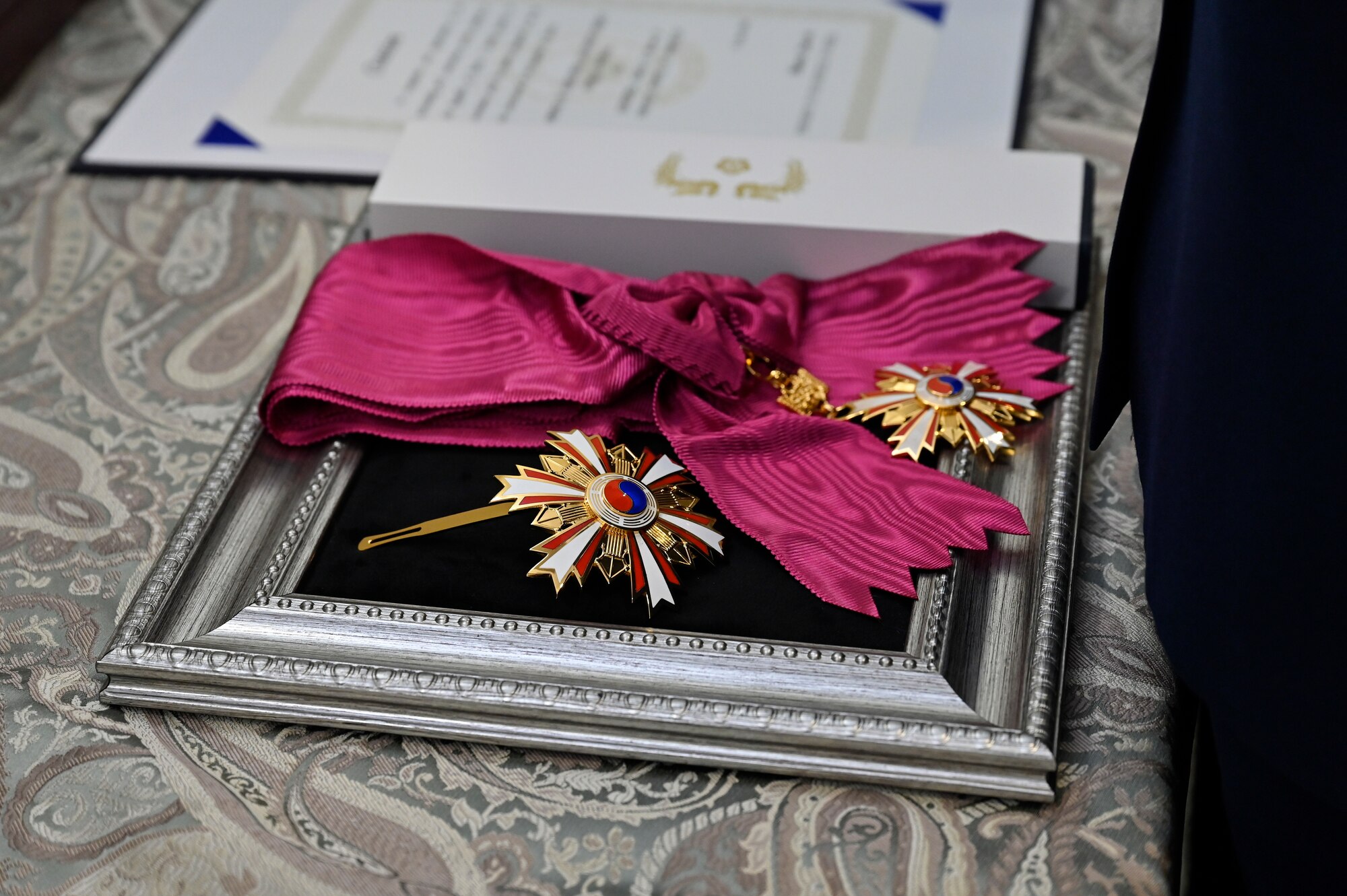 The Order of National Security Merit, Tong-Il Medal is placed on a presentation board before being awarded to Air Force Chief of Staff Gen. CQ Brown, Jr. by Chief of Staff of the Republic of Korea Air Force Gen. Park Inho.