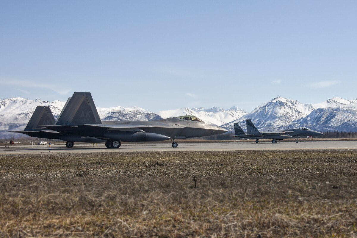 Two F-15C Eagles from the 144th Fighter Wing and two F-22 Raptors from the 3rd Fighter Wing prepare to take off from Joint Base Elmendorf-Richardson, Alaska, April 18, 2022, during an Aerospace Control Alert training scramble. It has been almost a decade since F-15 Eagles have sat alert in the region, protecting the airspace of the United States and Canada.