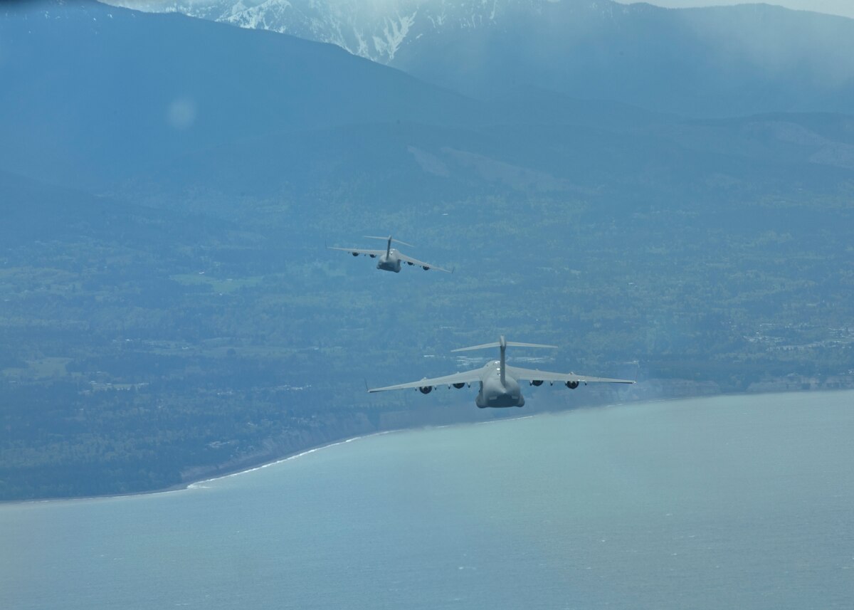 Two 62nd Airlift Wing C-17 Globemaster III’s prepare for aerial refueling over the Pacific Ocean May 7, 2022 during Exercise Swift Response. Exercise Swift Response  focuses on building airborne interoperability with Allies and partners, and the integration of joint service partners in a contested environment; testing the capability and operational reach to rapidly deploy and employ U.S. and Europe-based multi-national airborne forces with little to no warning from across the globe. (U.S. Air Force photo by Staff Sergeant Zoe Thacker)