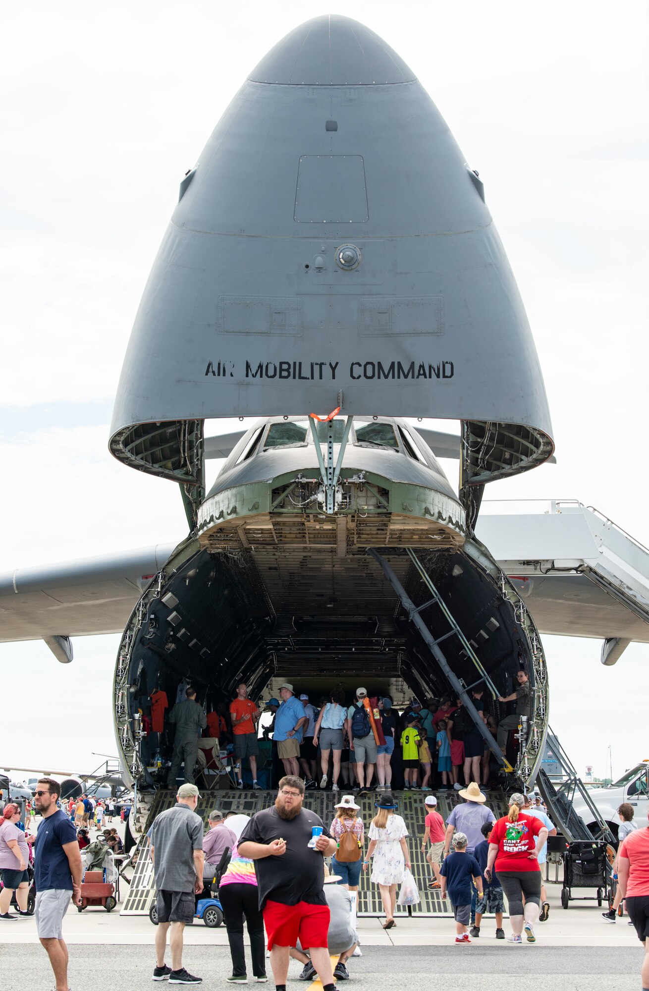 Airshow spectators enter the forward ramp of a C-5M Super Galaxy during the 2022 Thunder Over Dover Airshow at Dover Air Force Base, Delaware, May 21, 2022. The base opened its gates to the public for a free, two-day event to showcase the Air Force and the base’s mission of providing rapid global airlift every day of the year. (U.S. Air Force photo by Roland Balik)