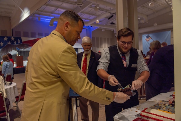 U.S. Marine Corps Sgt. Maj. James Robinson, sergeant major of Marine Corps Air Station (MCAS) Cherry Point, helps serve cake during the 19th Annual Salute to the Veterans event at the Havelock Tourist and Event Center, Havelock, North Carolina, May 10, 2022. The event was intended to foster the community relationship between Havelock and MCAS Cherry Point and honor service members for Military Appreciation Month. (U.S. Marine Corps photo by Lance Cpl. Symira Bostic)