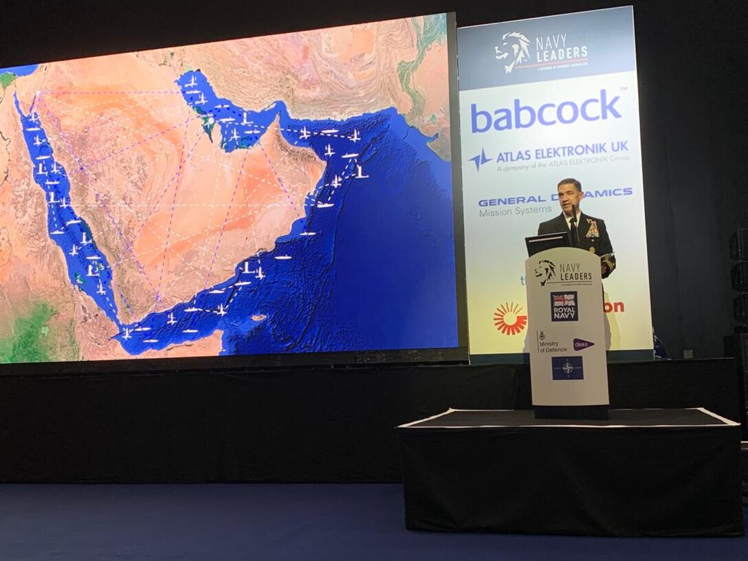 220524-N-NO146-1002 LONDON (May 24, 2022) Vice Adm. Brad Cooper, commander of U.S. Naval Forces Central Command, U.S. 5th Fleet and Combined Maritime Forces, speaks about unmanned systems and artificial intelligence in naval operations at an international security conference at the Farnborough International Exhibition and Conference Centre, May 24.