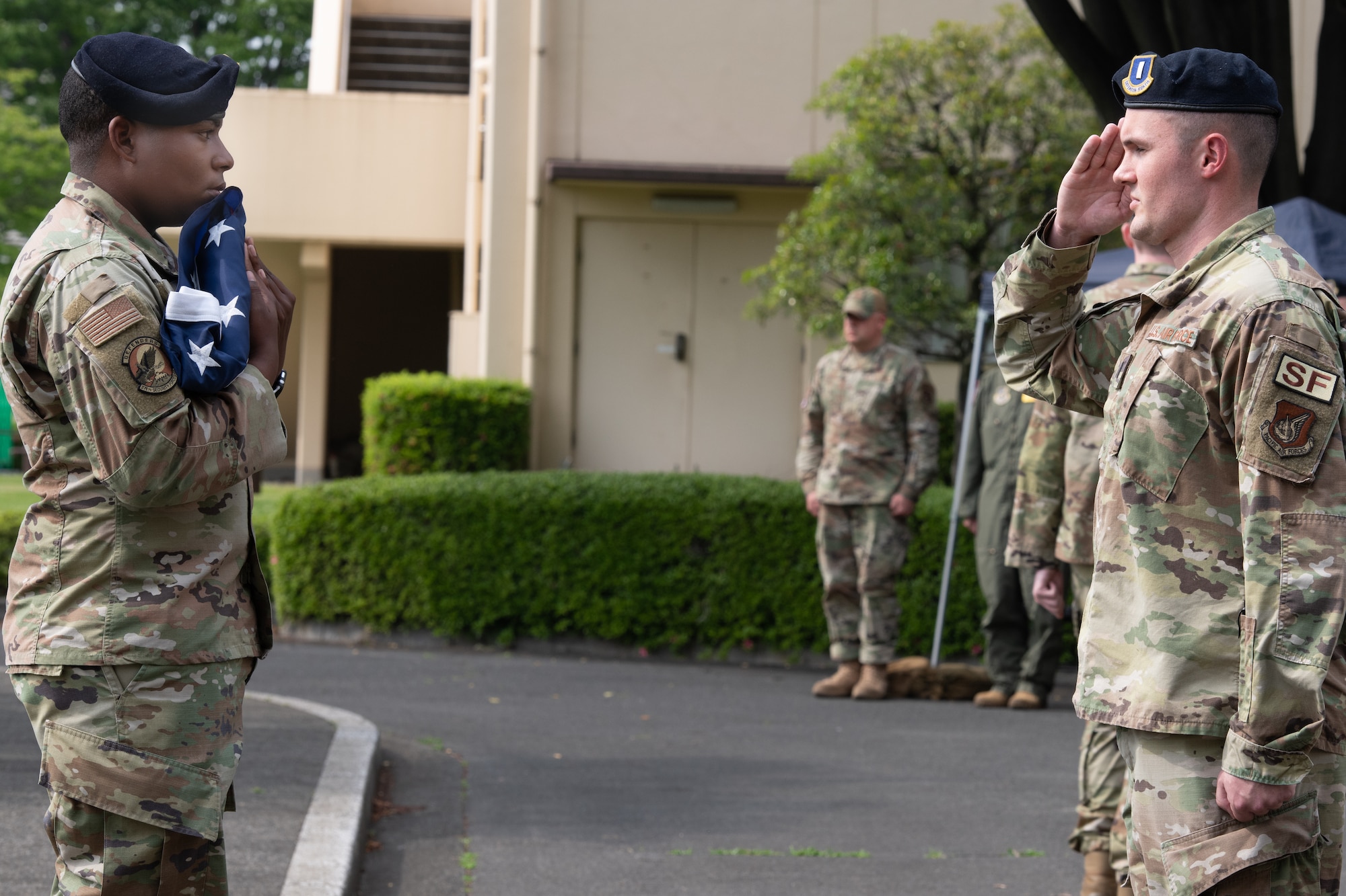 Operations officer for the 374th Security Forces Squadron, 1st Lt. Evan Loosen, , salutes the U.S. flag during a police retreat ceremony at Yokota Air Base, Japan, May 20, 2022. The 374th SFS held the ceremony during Police Week to honor law enforcement personnel as well as recognize the dangers and risks they face every day. (U.S. Air Force photo by Machiko Arita)