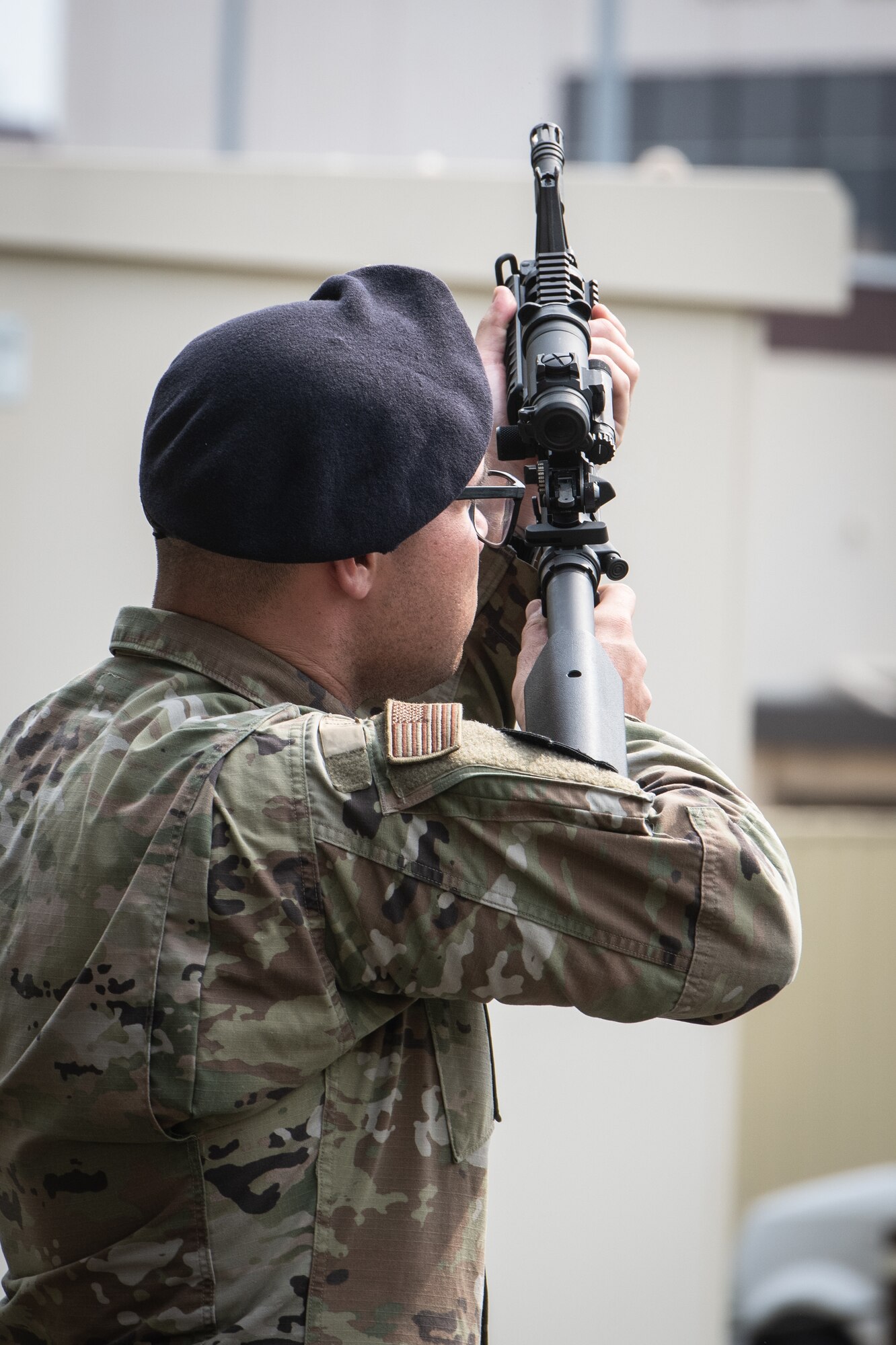 A member of the 374th Security Forces Squadron fires a three round volley in honor of fallen law enforcement member during a police retreat ceremony at Yokota Air Base, Japan, May 20, 2022. The 374th SFS held the ceremony during Police Week to honor law enforcement personnel as well as recognize the dangers and risks they face every day. (U.S. Air Force photo by Machiko Arita)