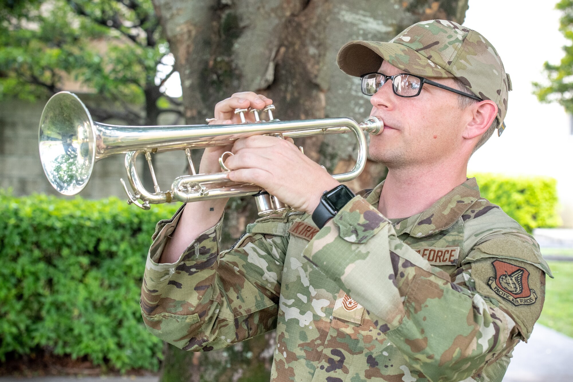 Tech. Sgt. Matthew Kirkpatrick, U.S. Band of the Pacific publicity section chief and trumpeter, play Taps during a police retreat ceremony at Yokota Air Base, Japan, May 20, 2022. The 374th SFS held the ceremony during Police Week to honor law enforcement personnel as well as recognize the dangers and risks they face every day. (U.S. Air Force photo by Machiko Arita)