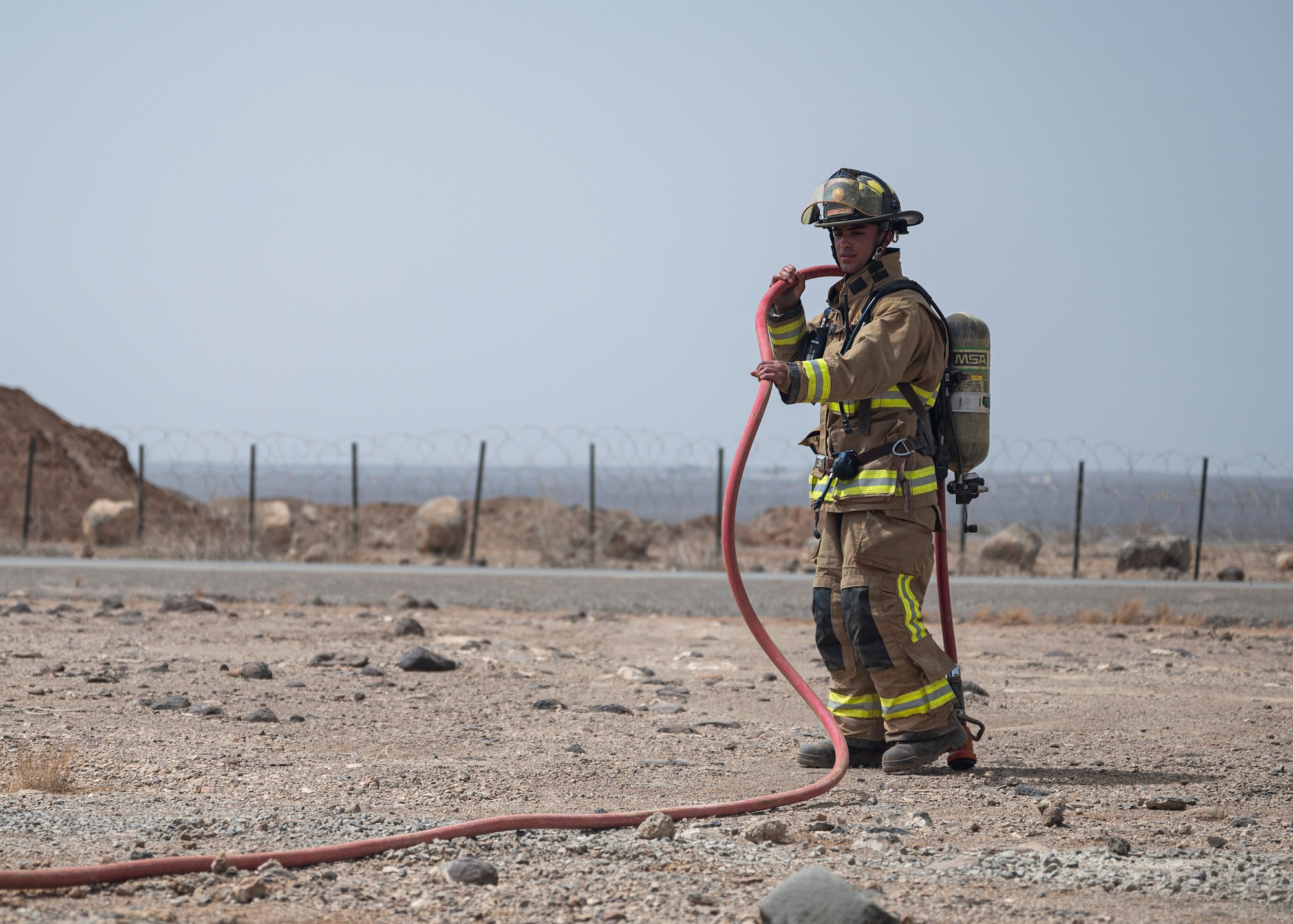 A firefighter operates a water hose during the Major Accident