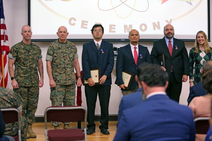 Charles Phelps, Shane Hillhouse and David Lin were awarded the Meritorious Civilian Service medal by Colonel Michael Fitzgerald during the Marine Corps Logistics Base (MCLB) Albany Net Zero Ceremony, May 24, 2022, on behalf of the Secretary of the Navy. These awards acknowledge the professional achievements while serving in direct support of the MCLB Albany Energy Program. These individuals were critical to the successful execution of over a decade worth of energy projects and initiatives. From concept and design through commissioning, they served in key roles on the three energy savings performance contracts, the electrical grid modernization, the 31-megawatt solar photovoltaic farm, the installation of the two landfill gas generators and the facility-related control system. These efforts were critical to MCLB Albany’s proud accomplishment of being the first installation in the Department of Defense to be Net Zero, ensuring energy security and resiliency within the Marine Corps.