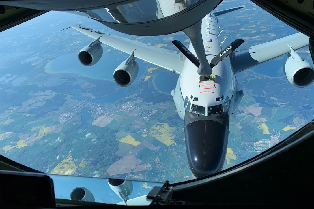 One airplane refuels another in flight.