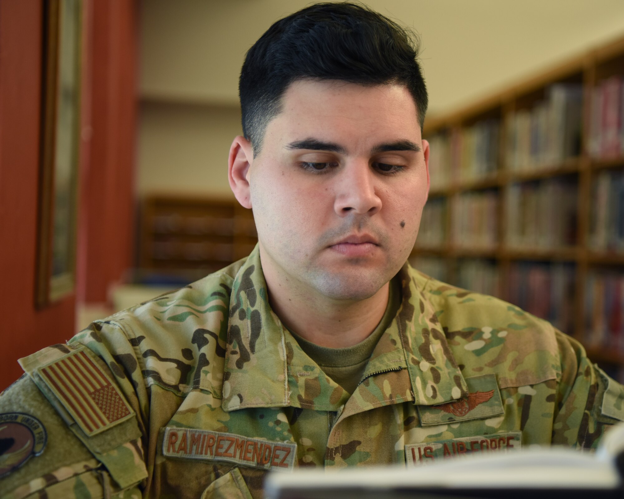 U.S. Air Force Staff Sgt. Ramon Ramirez-Mendez, 316th Training Squadron instructor, reads his course textbook at the Consolidated Learning Center, Goodfellow Air Force Base, Texas, May 23, 2022. Ramirez-Mendez is fully invested in his role as a student as it helps him be a more effective and engaging instructor. (U.S. Air Force photo by Senior Airman Ethan Sherwood)