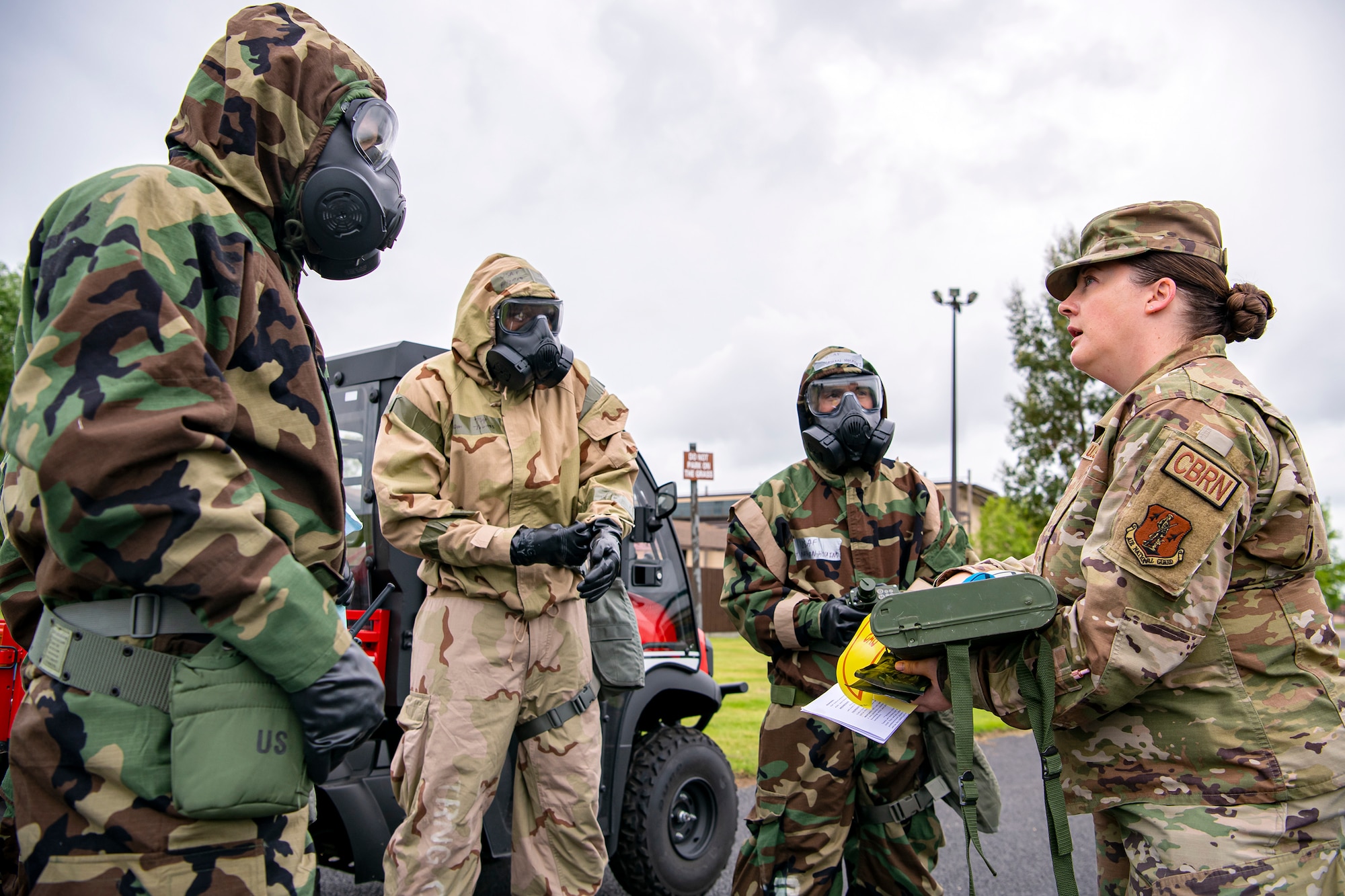 Master Sgt. Kate Menges, 423d Civil Engineer Squadron emergency management craftsman, briefs airmen prior to an exercise at RAF Alconbury, England, May 19, 2022. The exercise was geared towards training Airmen on how to properly control and examine a contaminated area after a simulated chemical attack while in Mission Oriented Protective Posture Gear. (U.S. Air Force photo by Staff Sgt. Eugene Oliver)