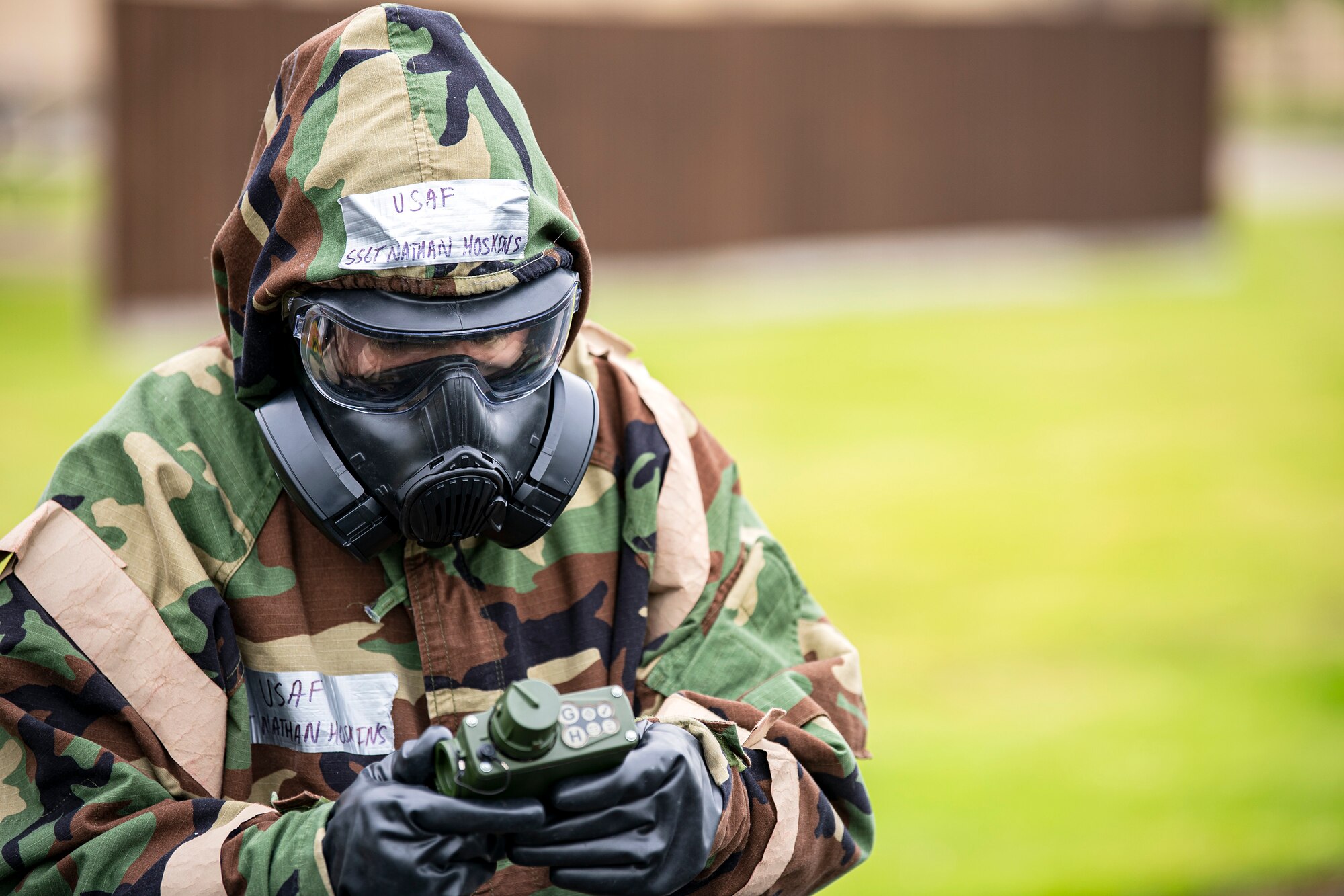 An Airman from the 423d Civil Engineer Squadron, uses a joint chemical agent detector during an exercise at RAF Alconbury, England, May 19, 2022. The exercise was geared towards training Airmen on how to properly control and examine a contaminated area after a simulated chemical attack while in Mission Oriented Protective Posture Gear. (U.S. Air Force photo by Staff Sgt. Eugene Oliver)