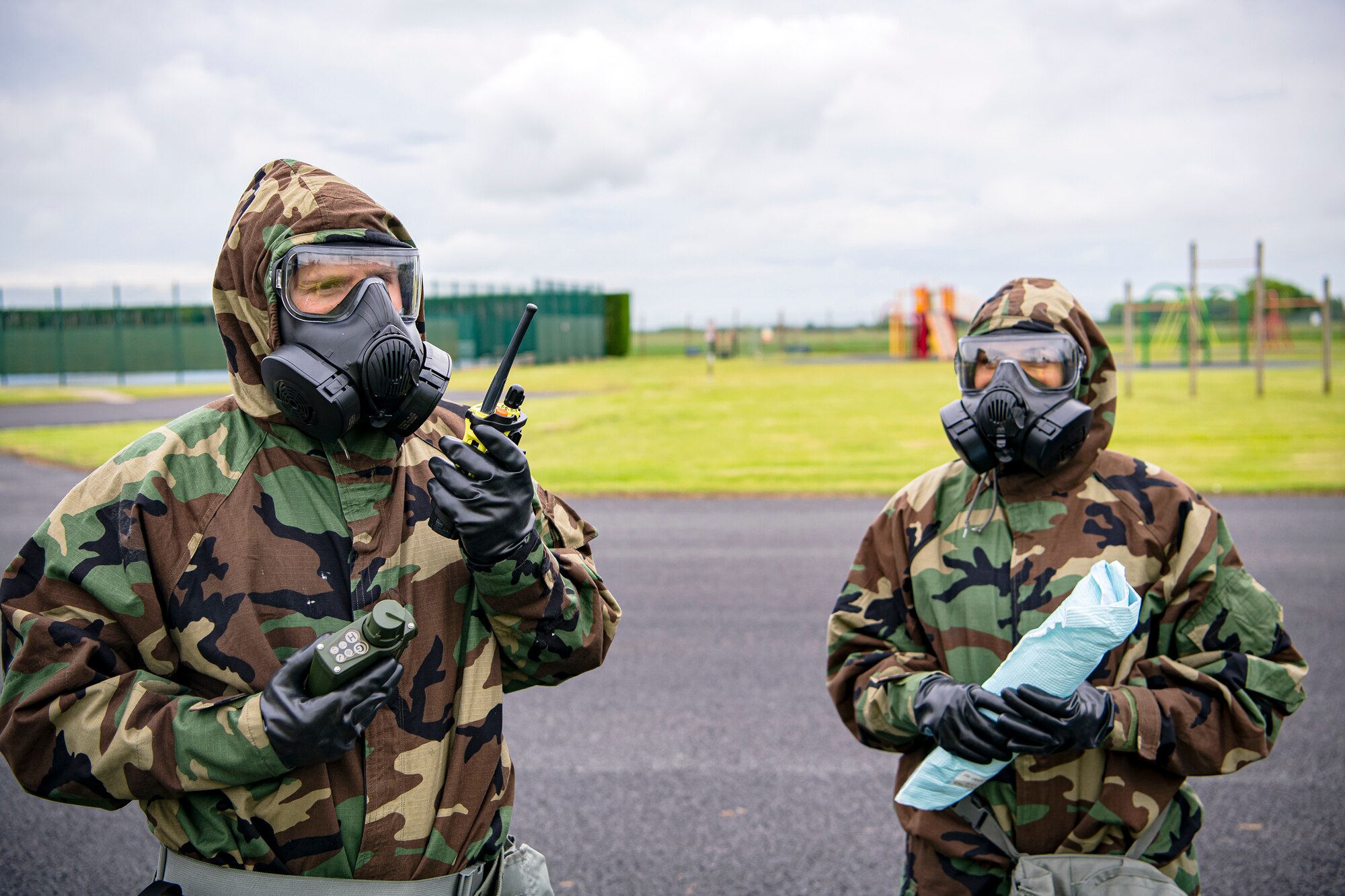 An Airman from the 423d Civil Engineer Squadron, speaks into a microphone during an exercise at RAF Alconbury, England, May 25, 2022. The exercise was geared towards training Airmen on how to properly control and examine a contaminated area after a simulated chemical attack while in Mission Oriented Protective Posture Gear. (U.S. Air Force photo by Staff Sgt. Eugene Oliver)