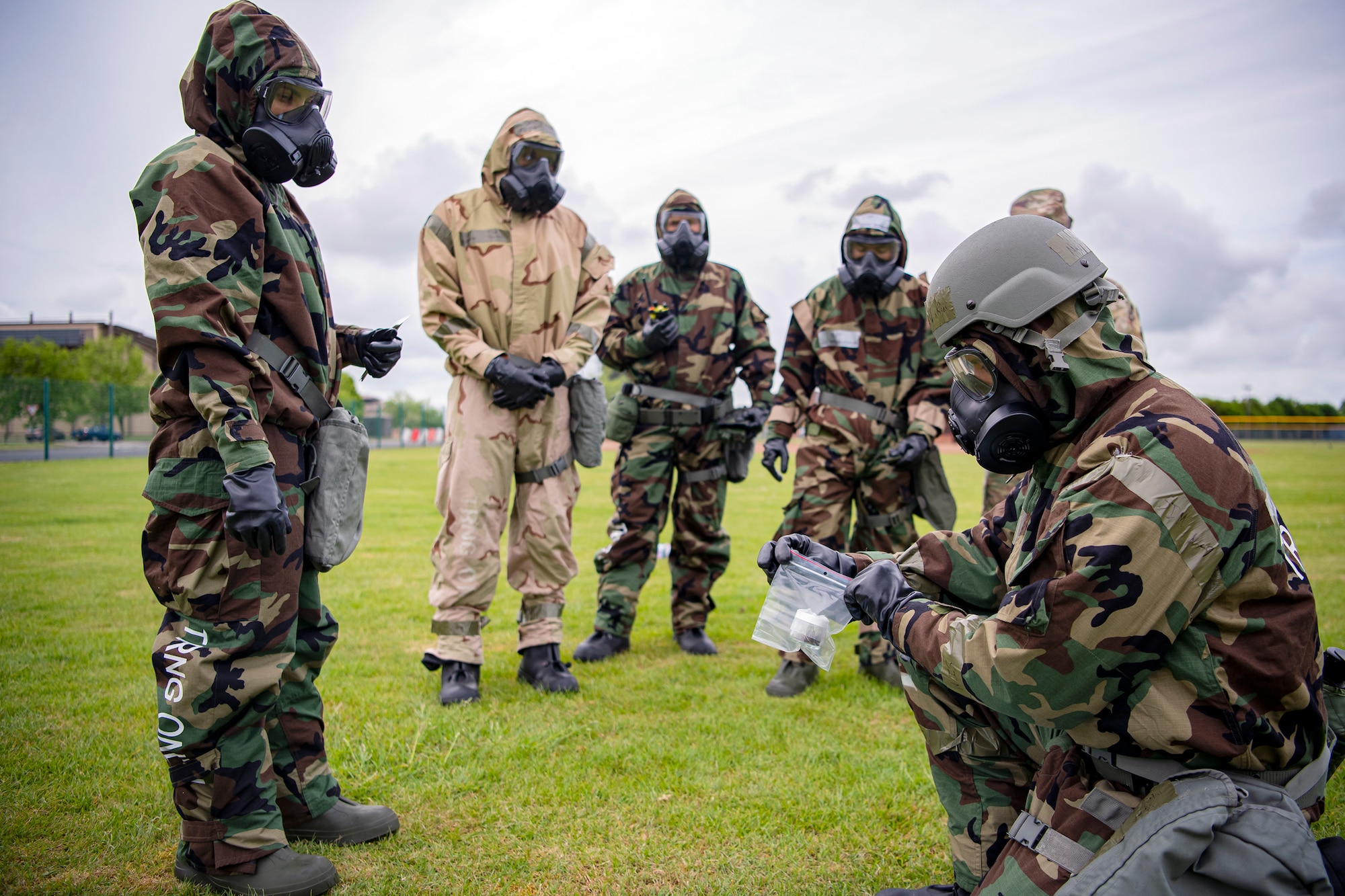 U.S. Air Force Lt. Col. Hans Winkler, right, 423d Civil Engineer Squadron commander, seals a soil sample during an exercise at RAF Alconbury, England, May 19, 2022. The exercise was geared towards training Airmen on how to properly control and examine a contaminated area after a simulated chemical attack while in Mission Oriented Protective Posture Gear. (U.S. Air Force photo by Staff Sgt. Eugene Oliver)