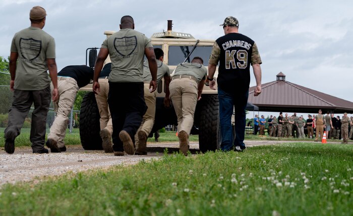 Airmen push Humvee