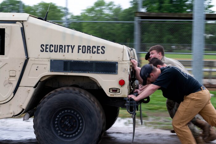 Airmen push Humvee