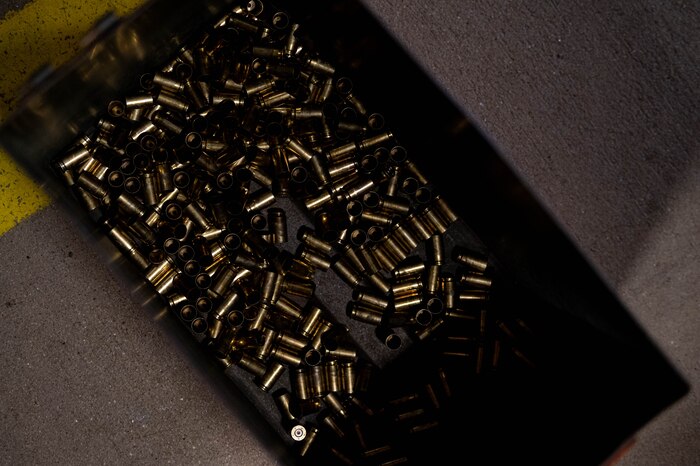 Spent shell casings sit in container