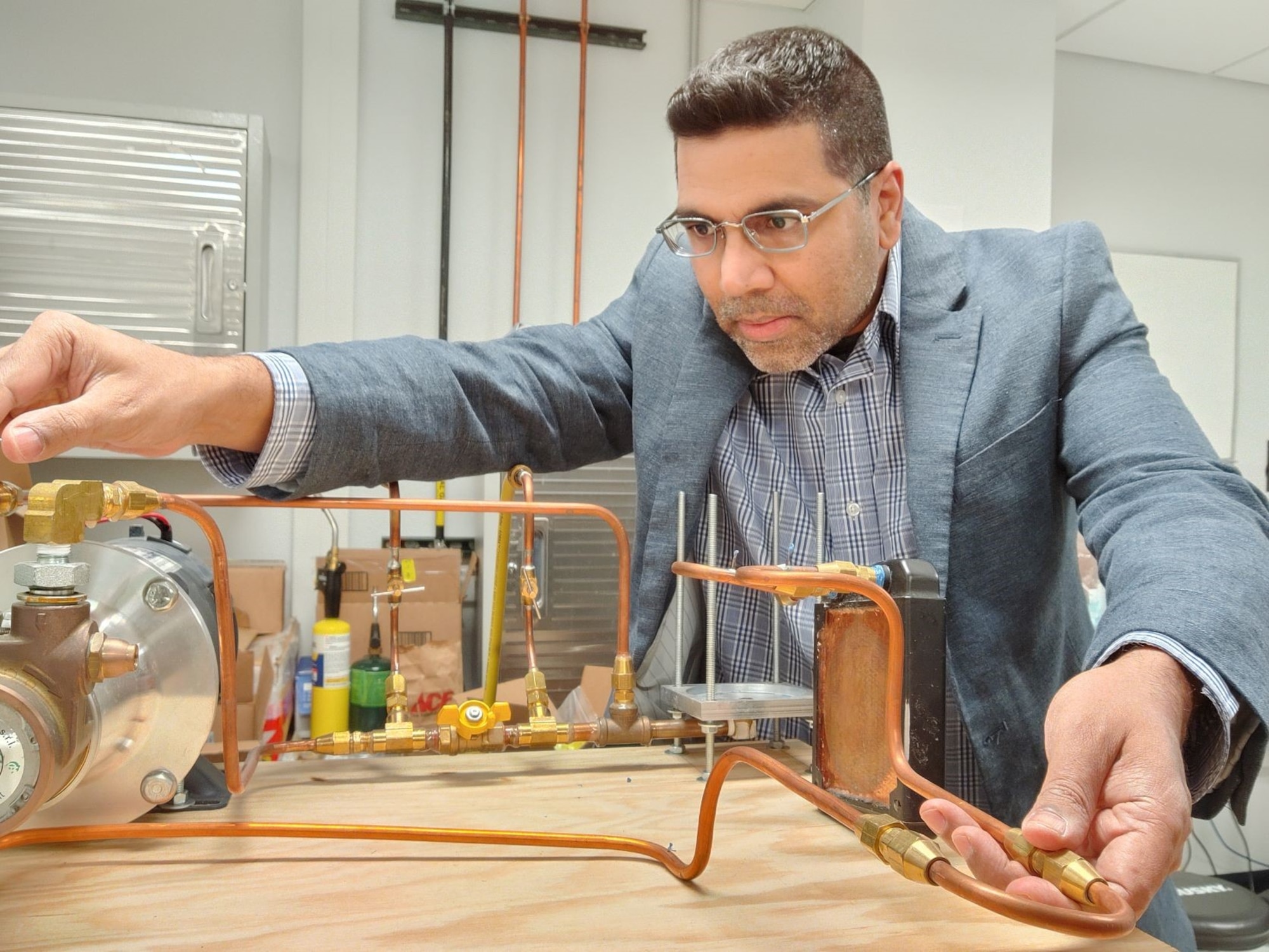 Using a laser diode system on loan from the Air Force Research Laboratory, New Mexico State University associate professor Dr. Krishna Kota tests the seal integrity of the cooling flow loop located in the Surface-environment Interaction Research Laboratory, or SIRE Lab, at NMSU. The flow loop will be used to test the ability of novel two-phase cooling approaches in handling the highly challenging, transient heat densities of directed energy weapon systems. (Courtesy photo)